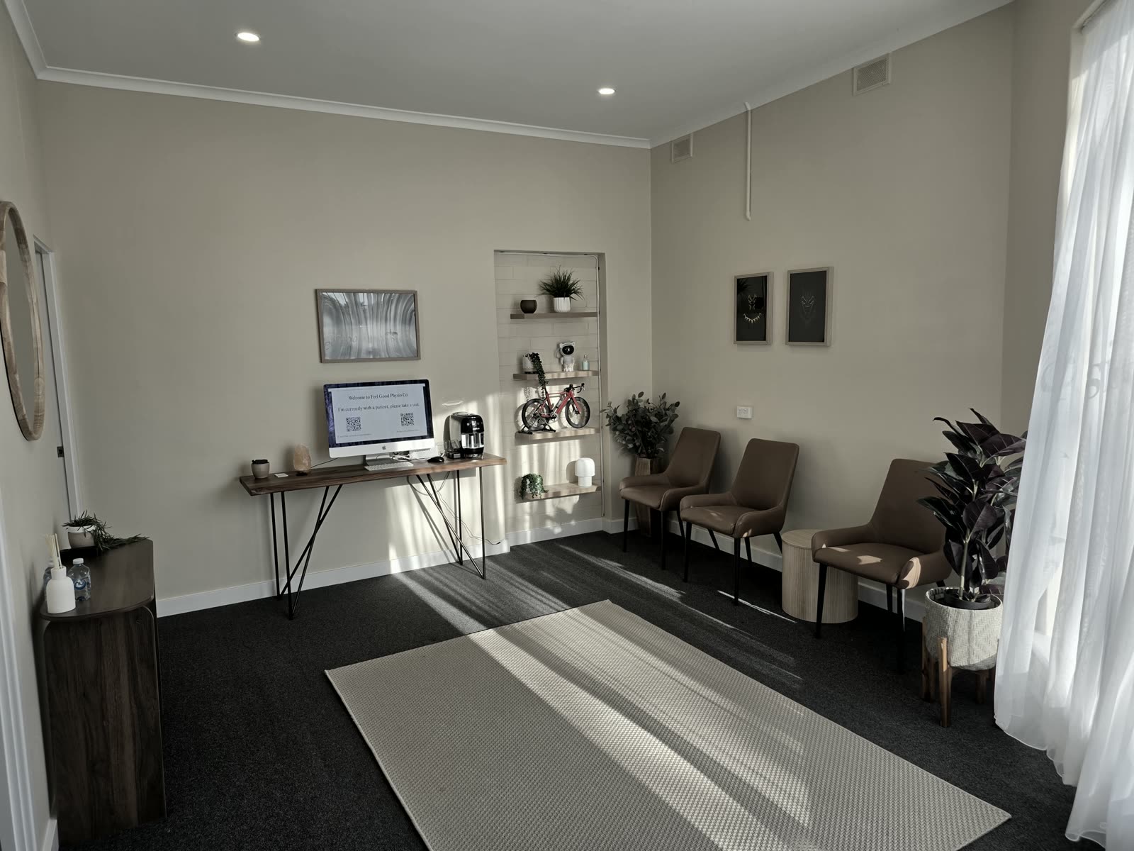 The waiting room at Feel Good Physio Co., Hampstead Gardens, with natural light and a bike on the shelf